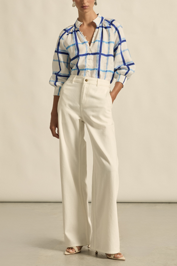 This front view of the Inspire Top in Azure Check showcases its high stand collar, relaxed fit, and lightweight 100% linen fabric with subtle check pattern.
