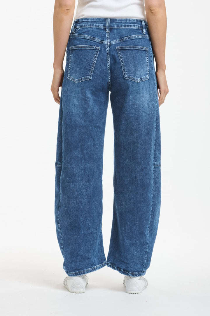 Blue jeans worn by a person on a white background