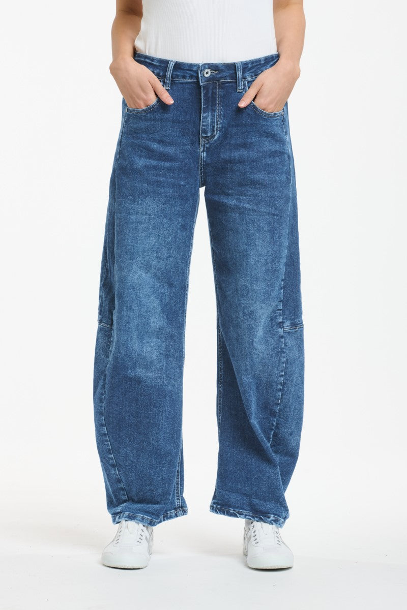 Person wearing blue jeans on a white background