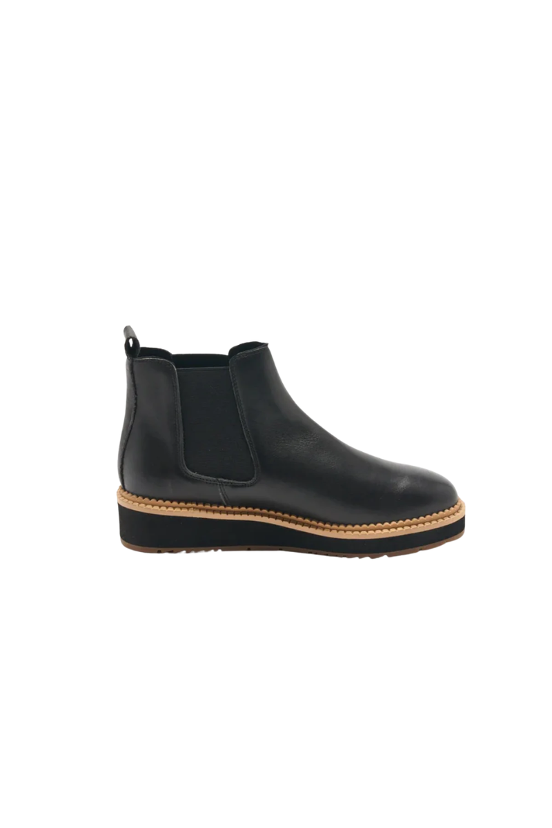 Black Chelsea boot with a platform sole on a white background