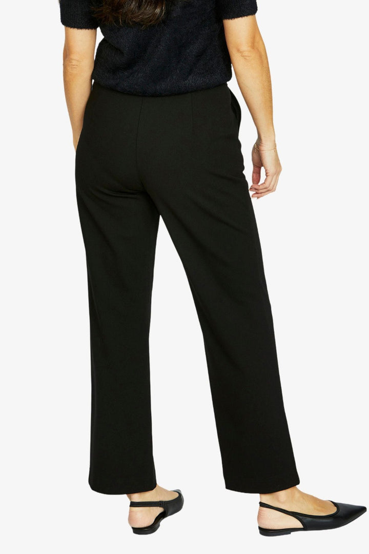Person wearing black dress pants on a white background