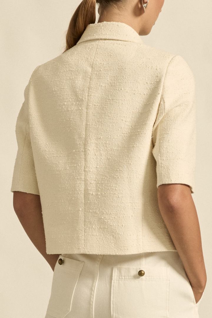 This back view of the Juncture Jacket in Alabaster highlights its tailored fit, subtle seam detailing, and streamlined design for a refined, elegant look.
