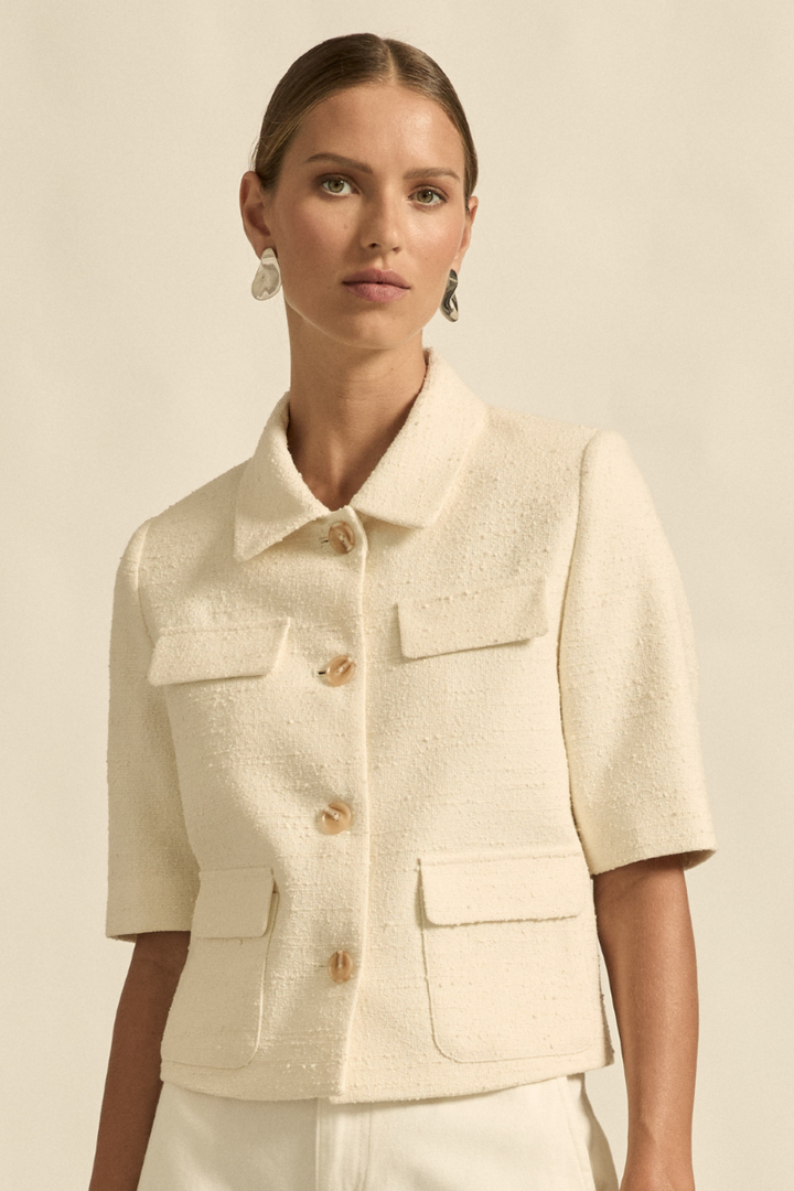 This close-up image of the Juncture Jacket in Alabaster showcases the soft fabric texture, clean stitching, and refined button details.
