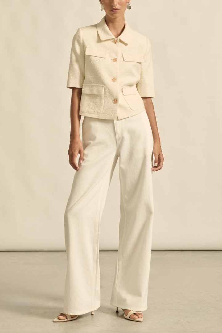This front view of the Juncture Jacket in Alabaster highlights its tailored fit, classic lapels, and minimalist button closure, perfect for a polished look.
