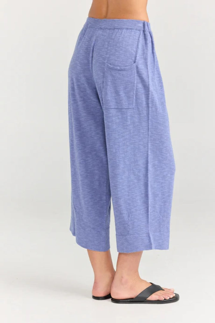 Blue pants worn by a person on a white background