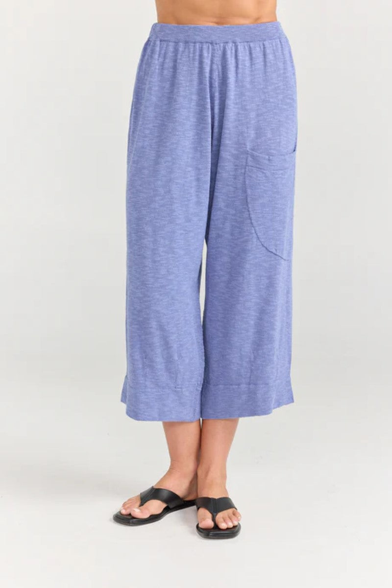 Blue wide-leg pants worn by a person on a white background