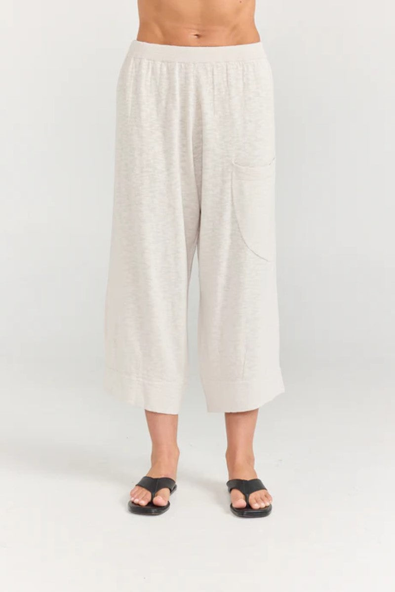 White wide-leg pants worn by a person on a white background