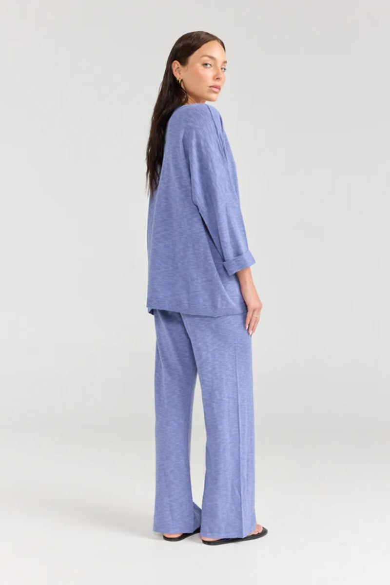 Woman wearing a blue outfit on a white background