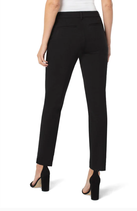 Woman wearing a and black chic trouser on a white background