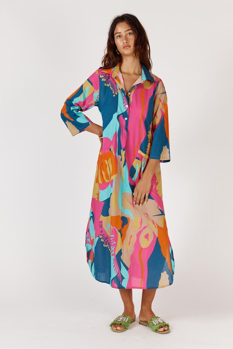 Woman wearing a colorful patterned dress on a white background