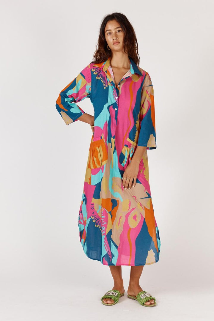 Woman wearing a colorful patterned dress on a white background