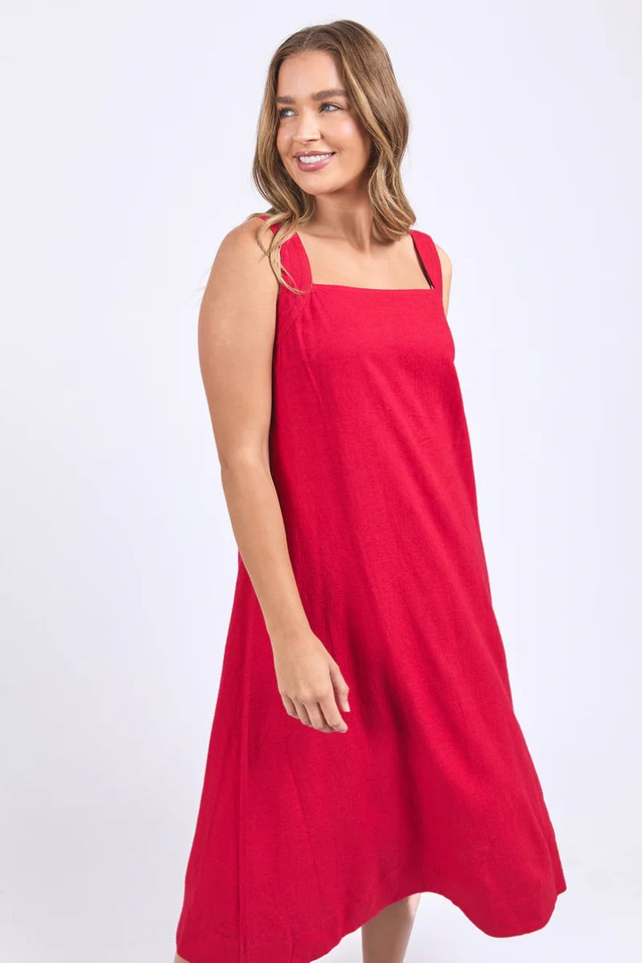 Woman wearing a red dress against a white background