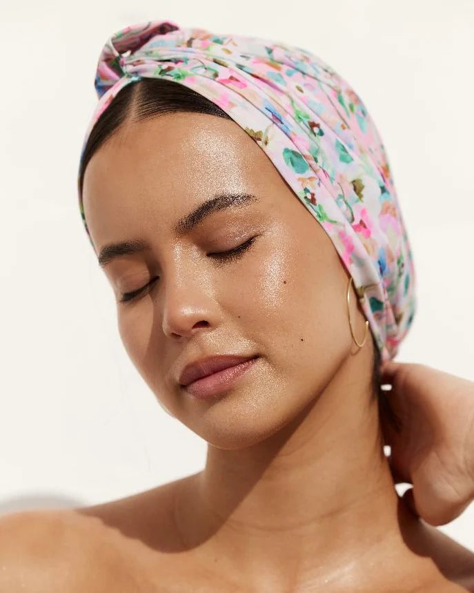Woman with a floral headscarf on a white background