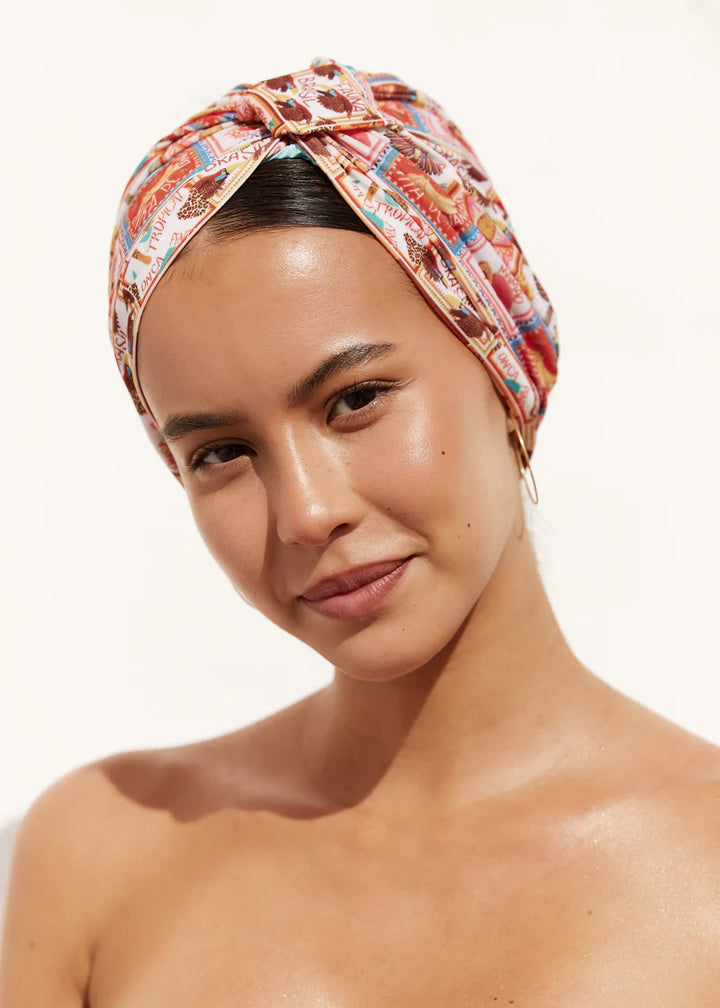 Woman wearing a patterned headscarf on a white background