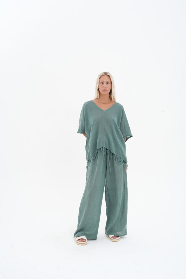 Woman wearing a green outfit on a white background