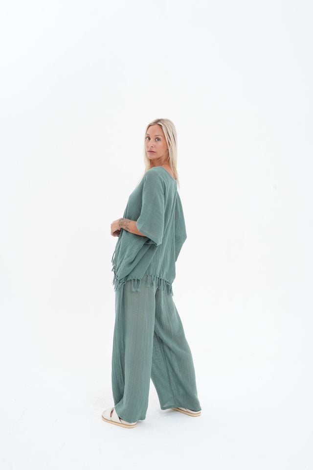 Woman wearing a green outfit on a white background