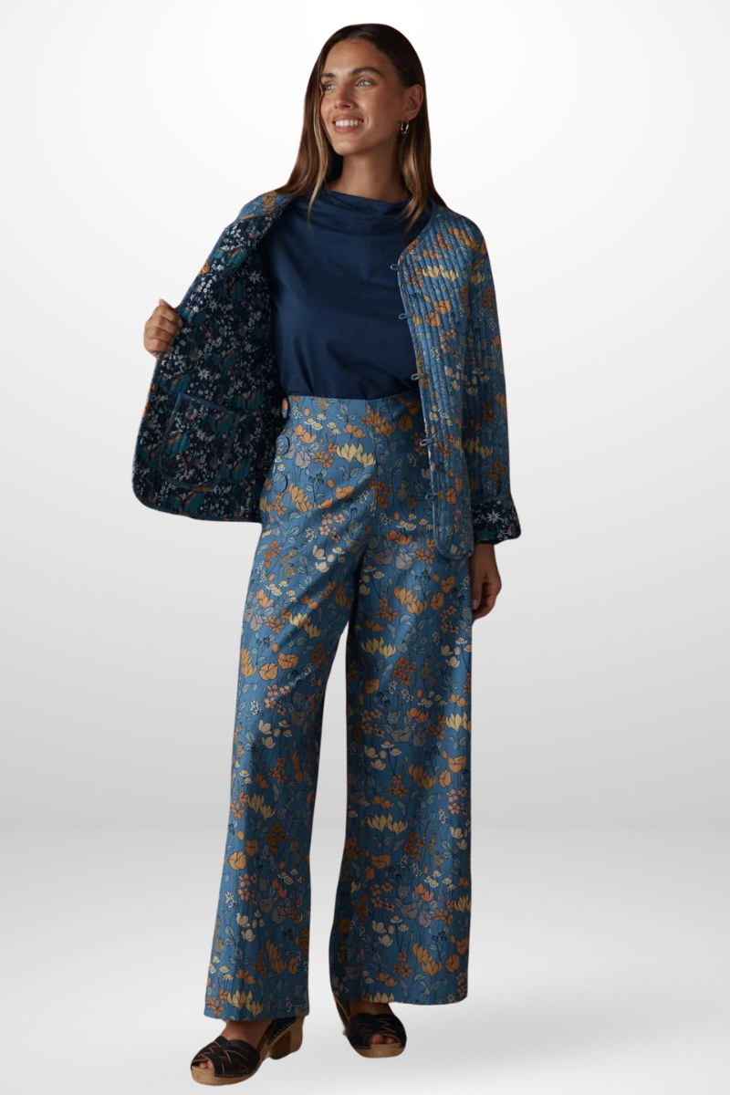 Woman wearing a blue floral outfit on a white background