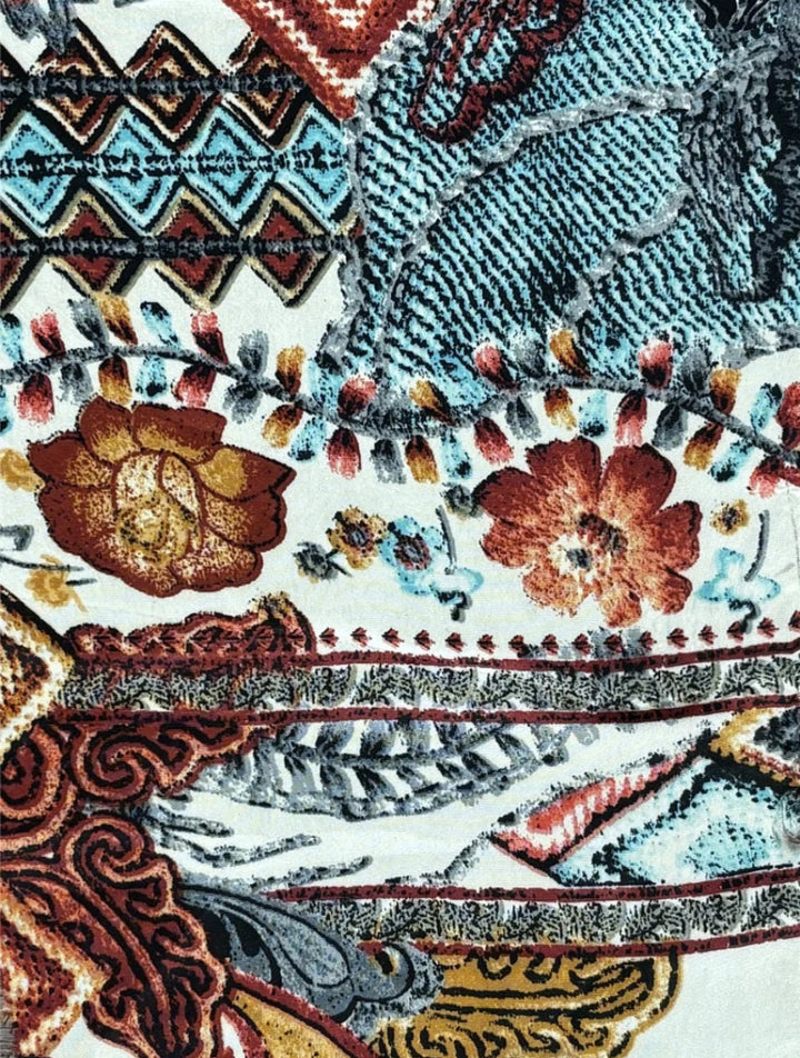 Close-up of colorful floral and geometric patterned fabric.