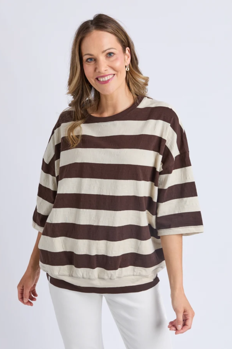 Woman wearing a brown and beige striped sweater on a white background