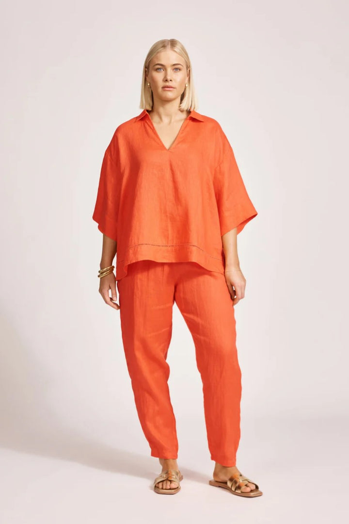 Woman wearing an orange outfit on a white background