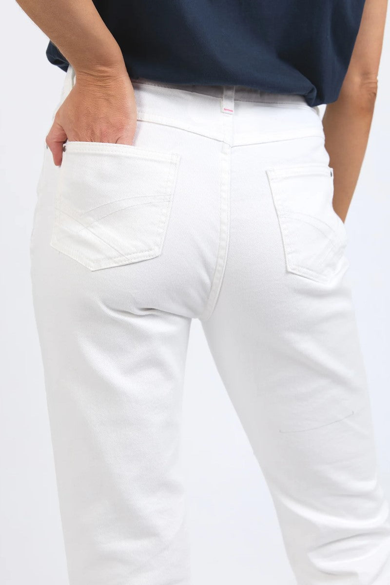 White pants worn by a person on a white background