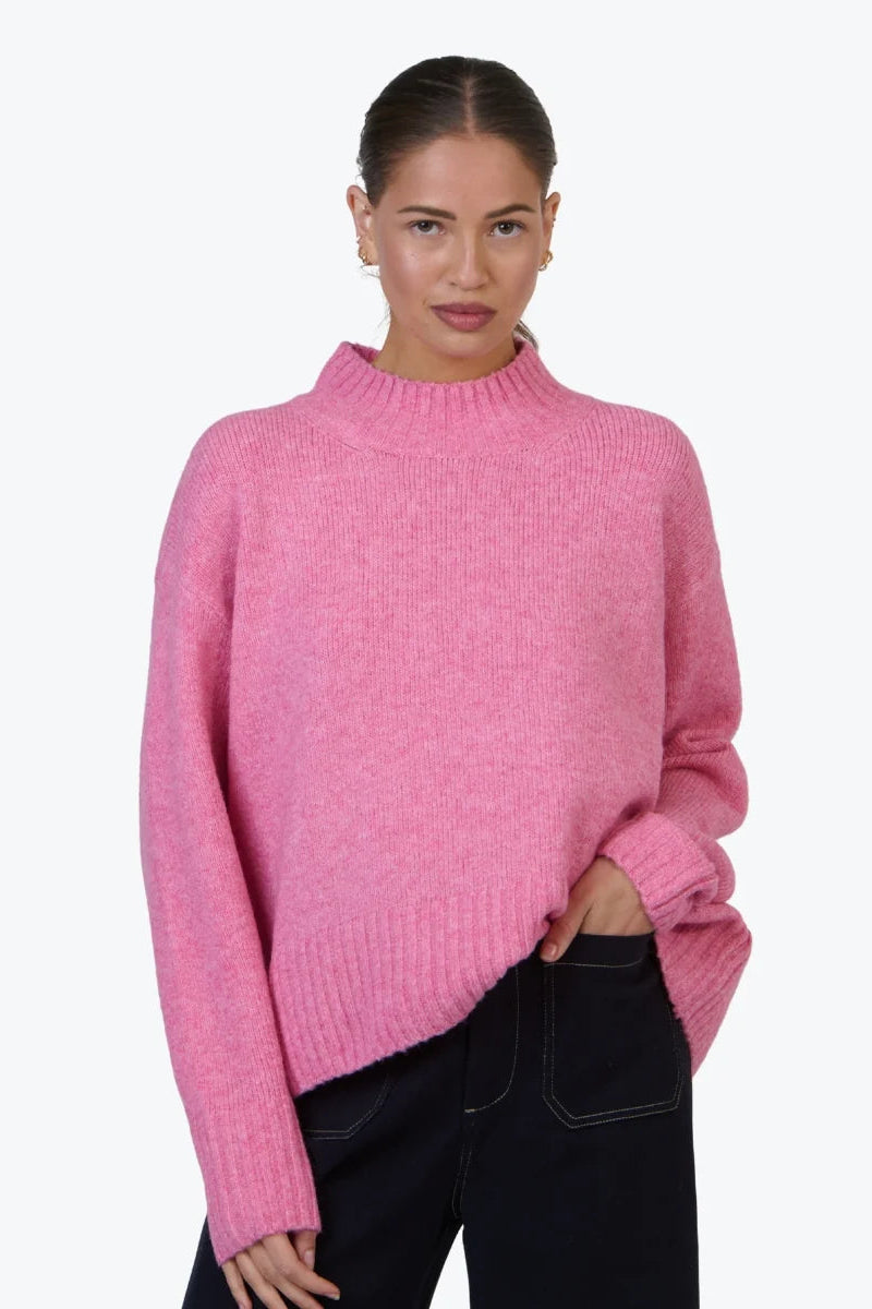Woman wearing a pink sweater on a white background