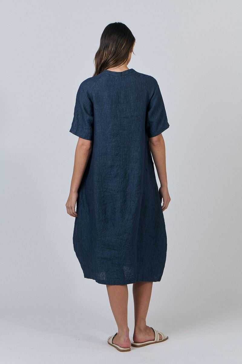 Woman wearing a blue dress against a white background