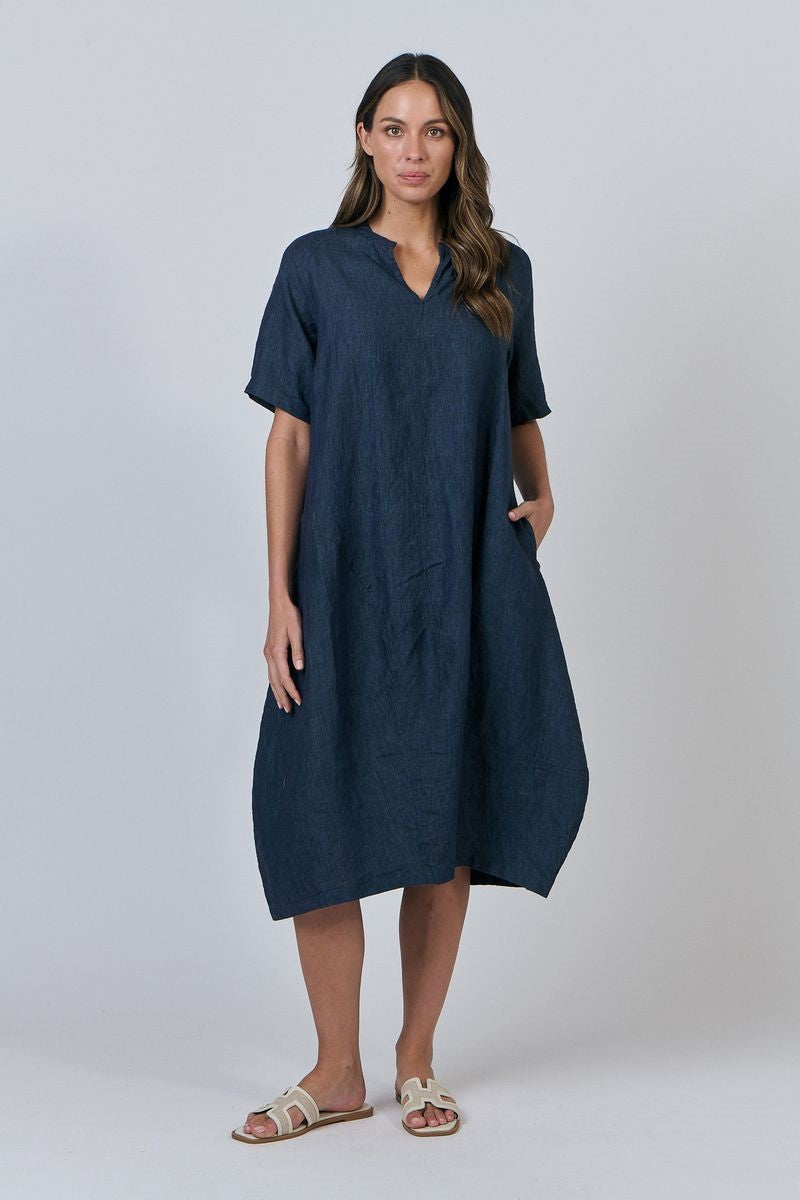 Woman wearing a navy blue dress on a white background