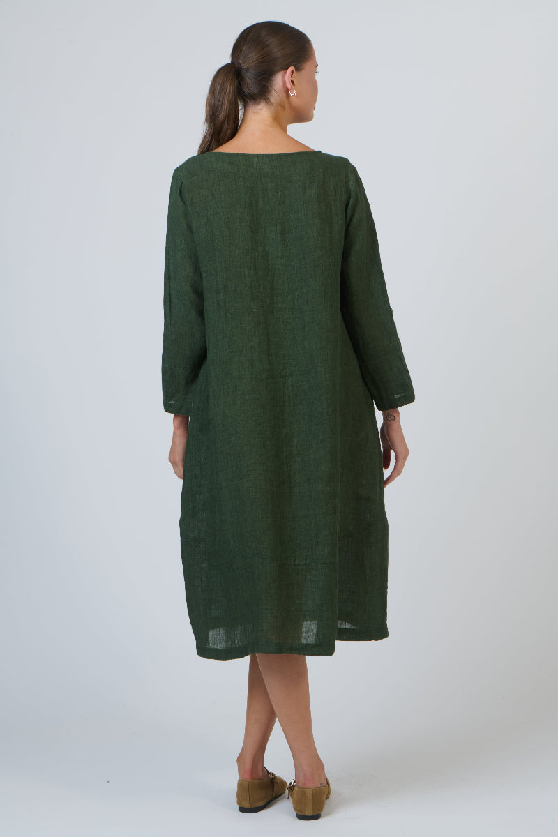 Woman wearing a green dress against a white background