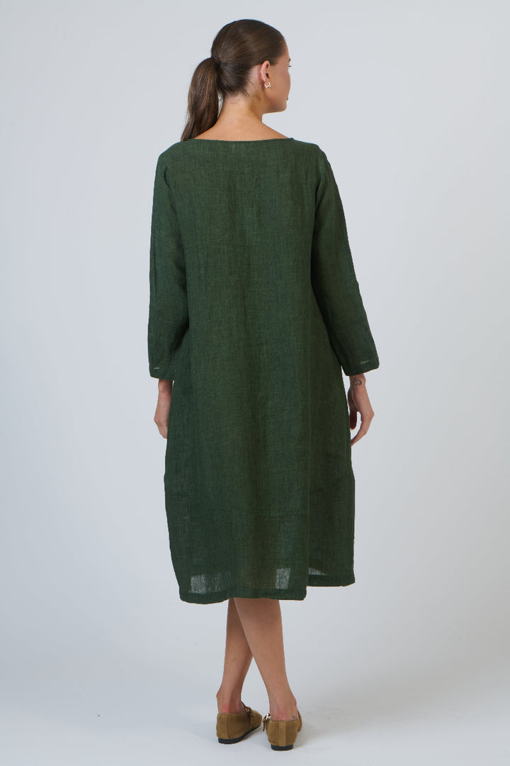 Woman wearing a green dress against a white background