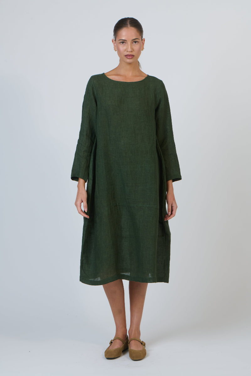 Woman wearing a green dress against a white background