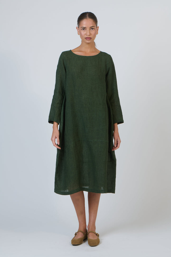 Woman wearing a green dress against a white background