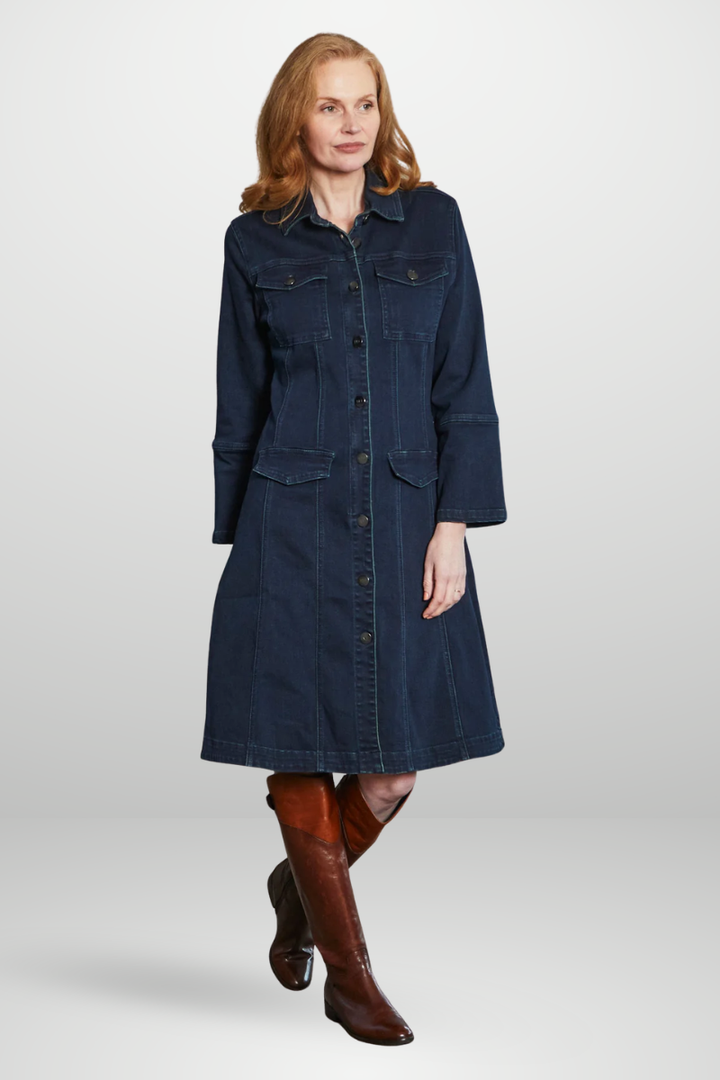 Woman wearing a denim dress with brown knee-high boots on a white background