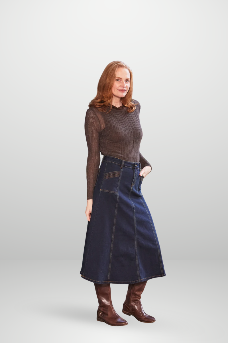 Woman wearing a brown top and blue skirt on a white background