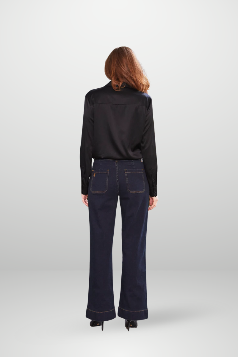Person wearing a black jacket and dark blue jeans on a white background