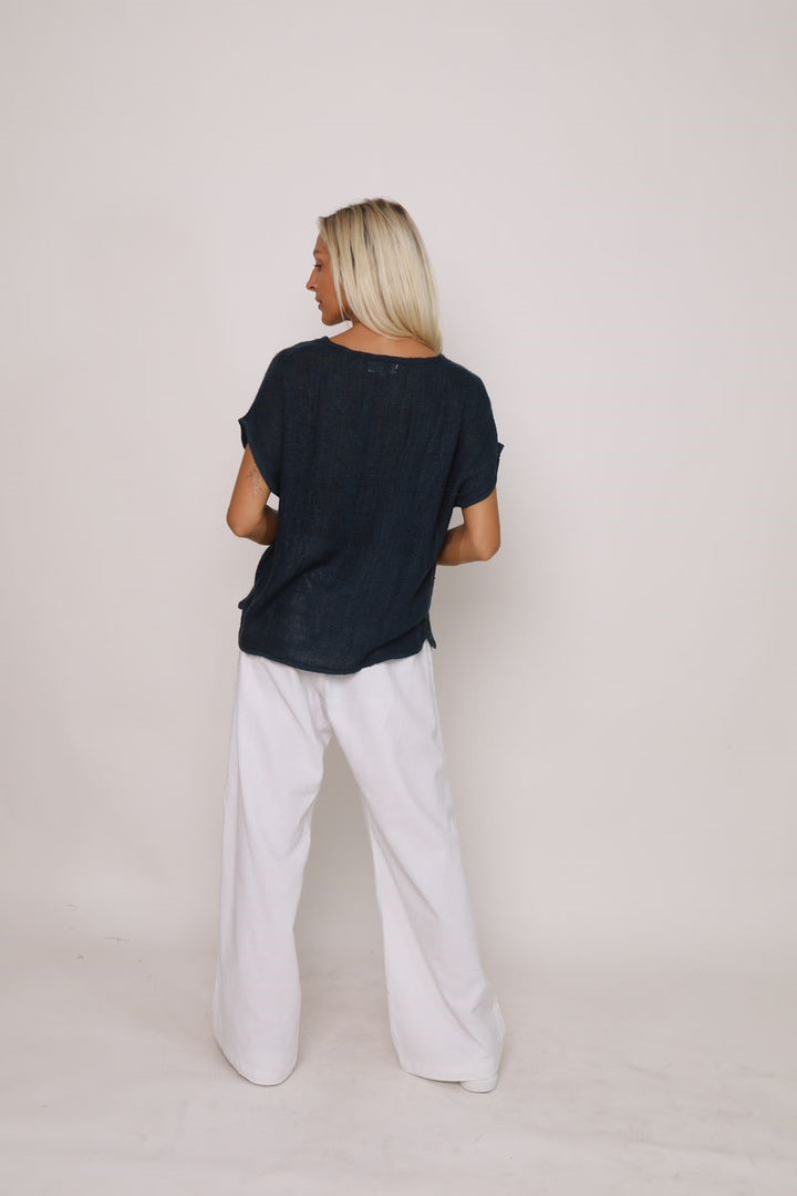 Back view of the Paris Top in black, displayed at Ivy Vibe, featuring a relaxed fit and breathable handwoven midweight cotton fabric.
