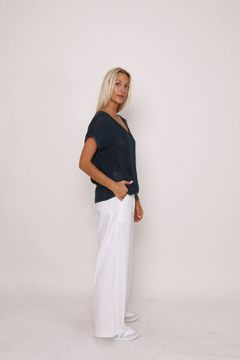 Side view of the Paris Top in black, showcased at Ivy Vibe, highlighting its relaxed fit, V-neckline, and handwoven midweight cotton fabric.