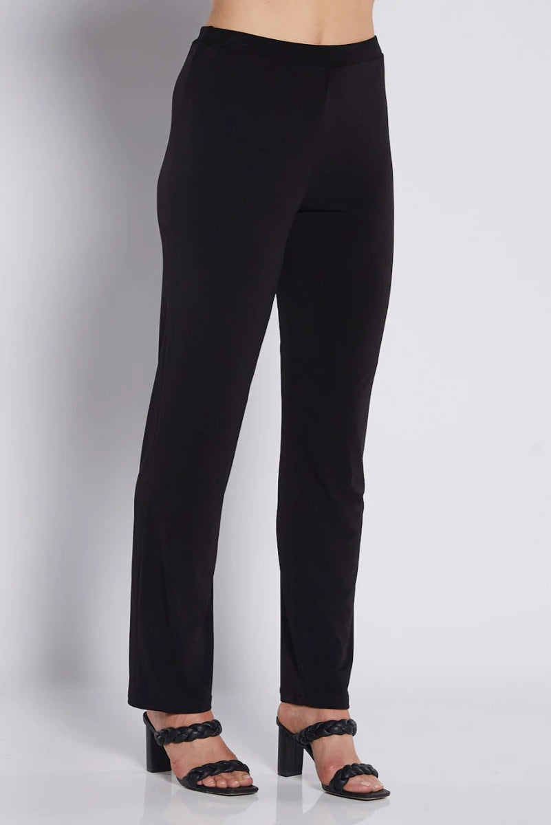 Black pants worn by a person on a white background