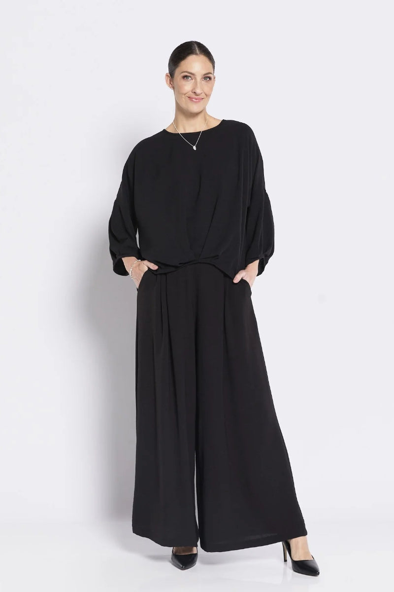 Woman wearing a black outfit on a white background