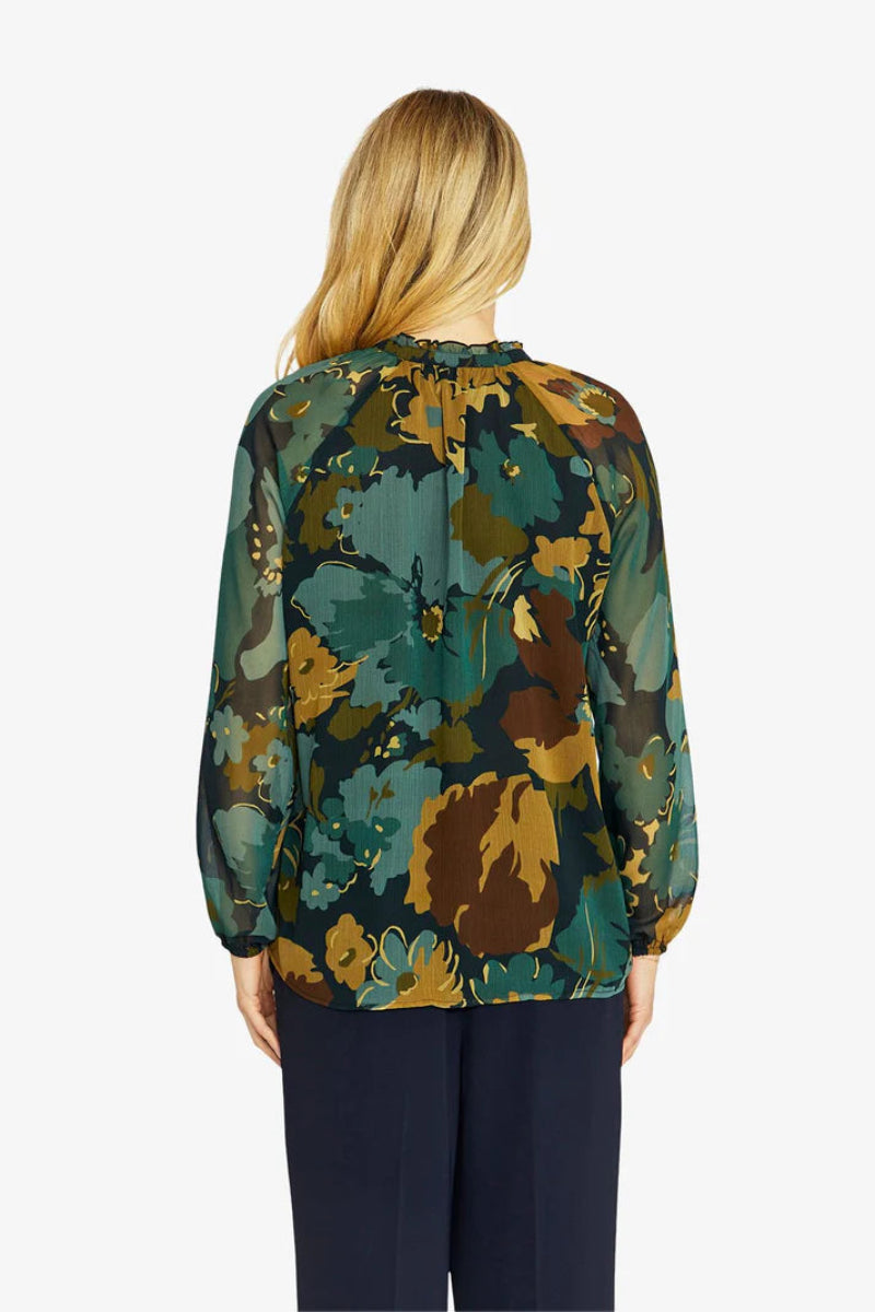 Woman wearing a floral blouse with a white background