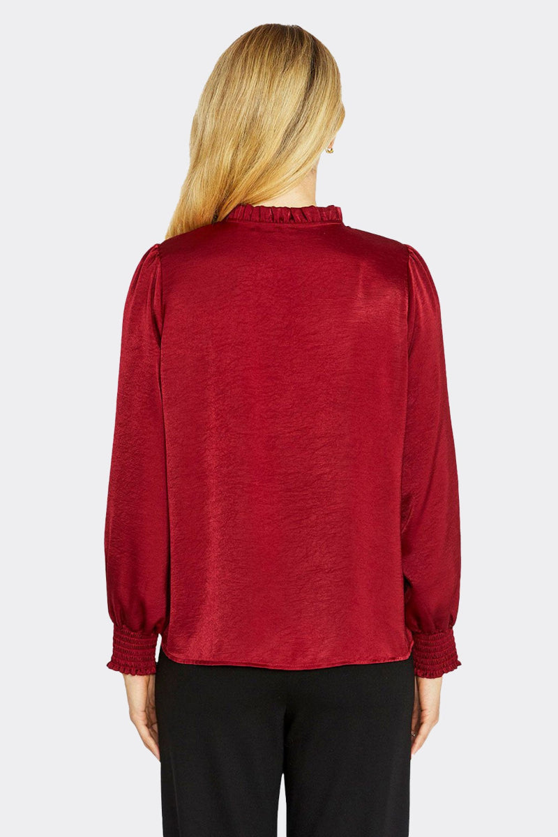 Red blouse worn by a person on a white background