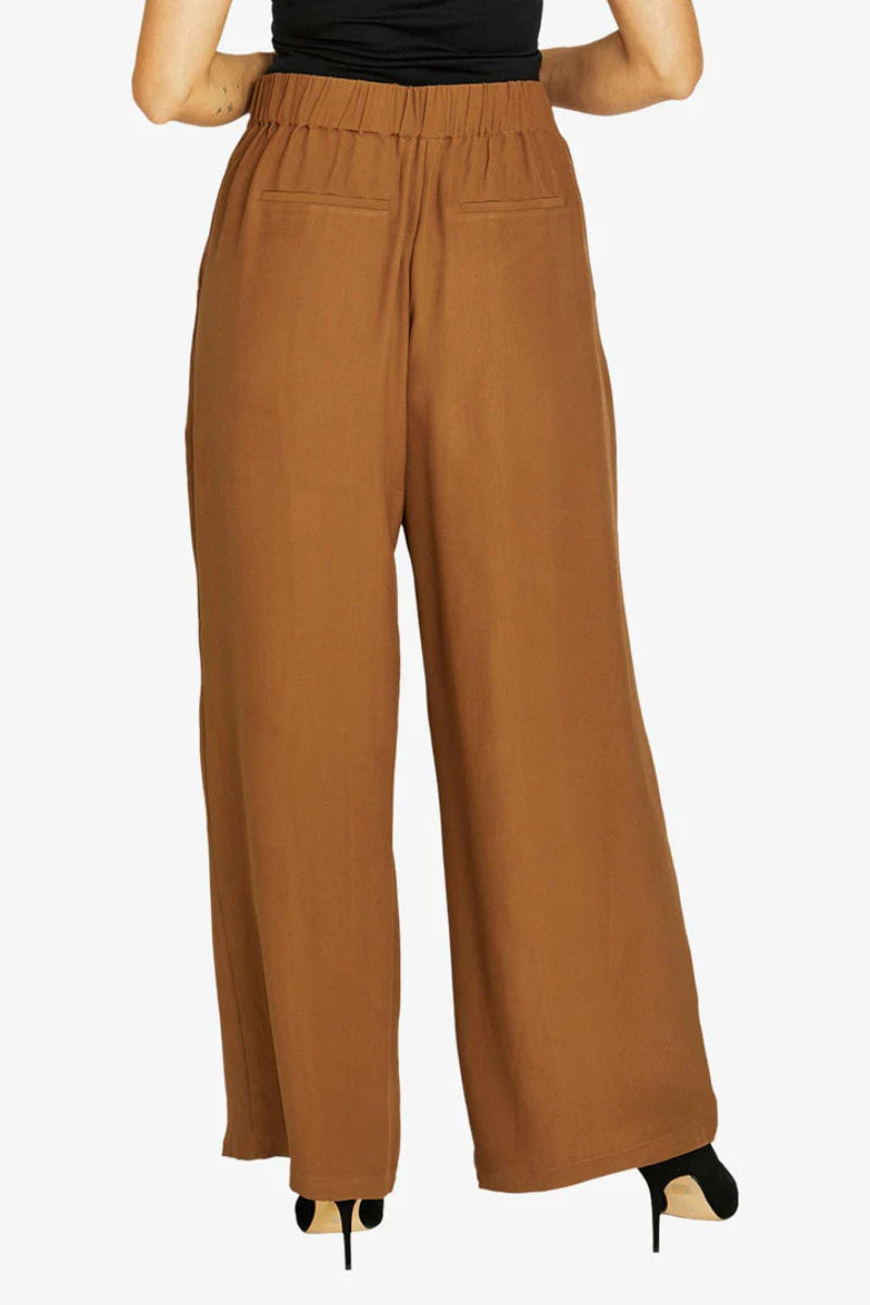 Brown wide-leg pants worn by a person on a white background