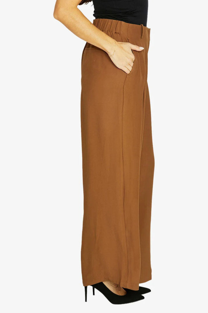 Brown wide-leg pants worn by a person on a white background