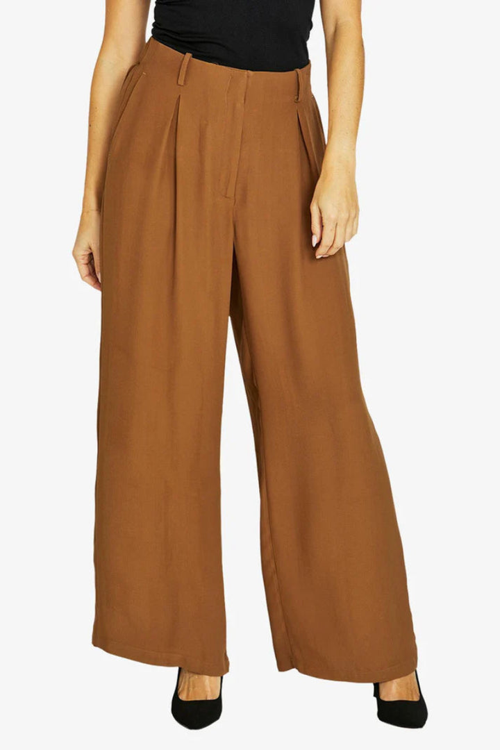 Brown wide-leg pants worn by a person on a white background
