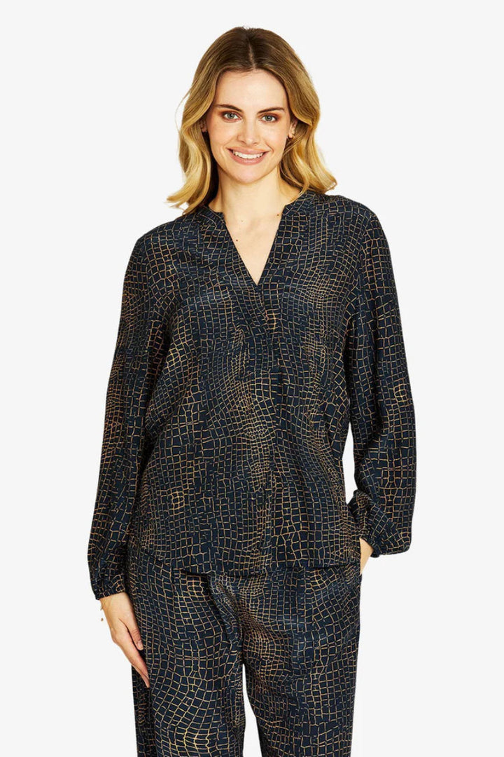 Woman wearing a dark patterned outfit on a white background