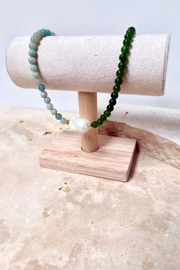 Beaded bracelet on a wooden stand with a neutral background