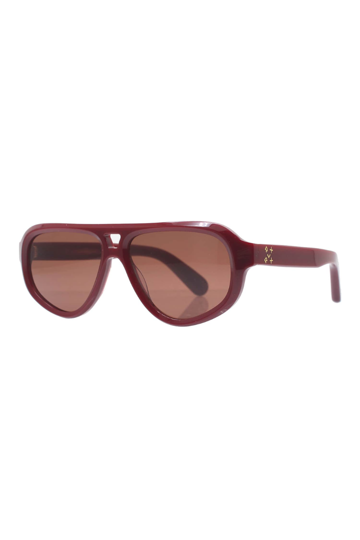 A pair of oversized aviator-style sunglasses with a translucent burgundy frame and brown tinted lenses, shown against a plain white background.