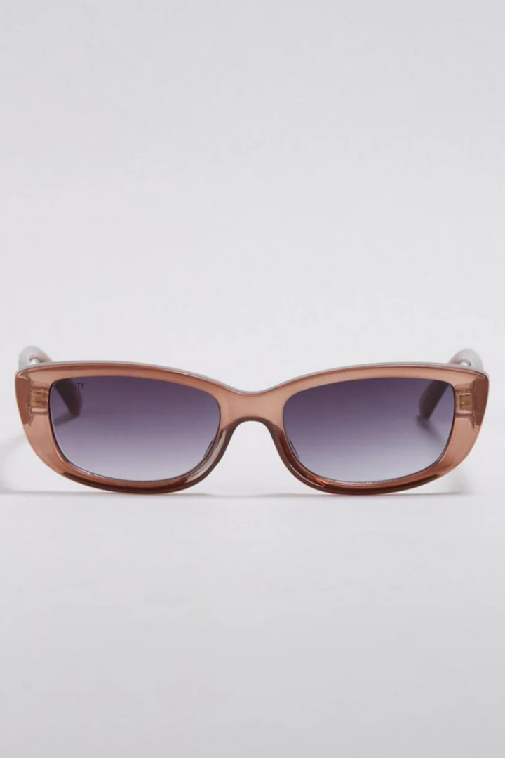 Brown sunglasses with gradient lenses on a light gray background