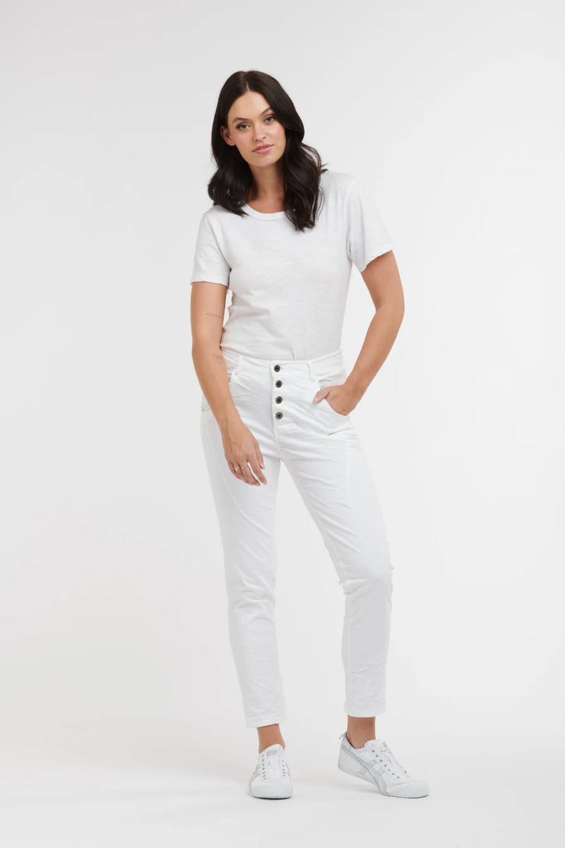 Woman wearing a white t-shirt and white pants on a white background
