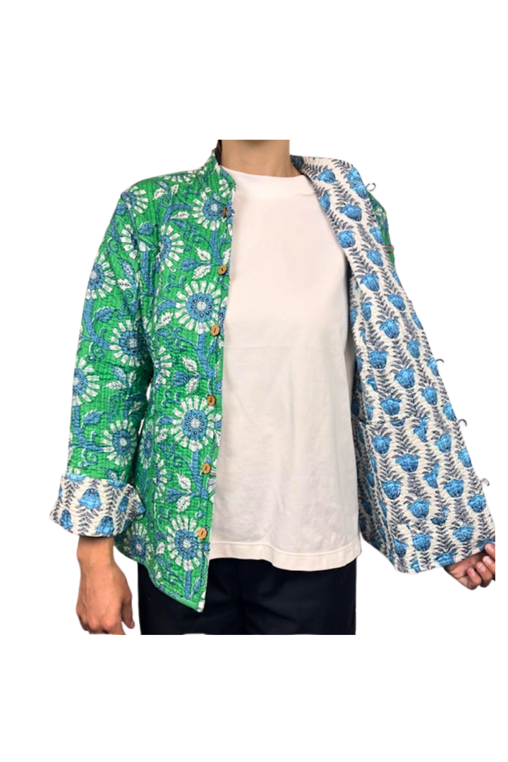 Person wearing a green floral patterned jacket over a white shirt on a white background